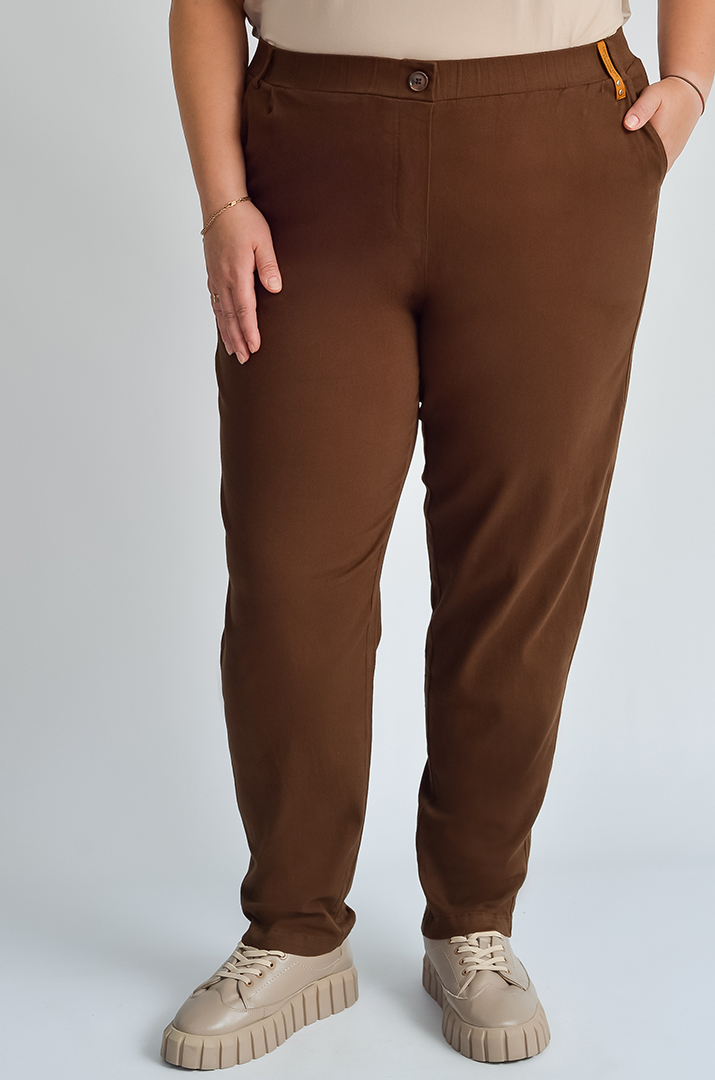 Завужені джинси з еластичним поясом і декоративним ґудзиком великих розмірів